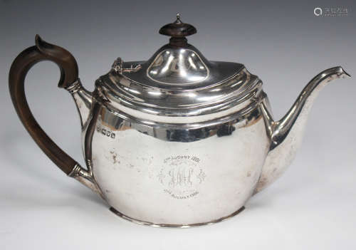 An Edwardian silver oval teapot with hinged lid and ebonized...