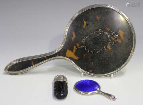 A George V silver and tortoiseshell dressing table hand mirr...