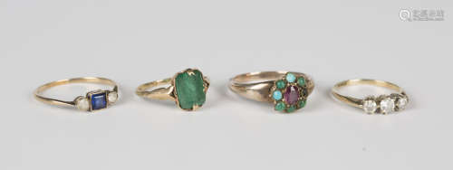 A gold ring, mounted with a rectangular cut pale emerald, we...
