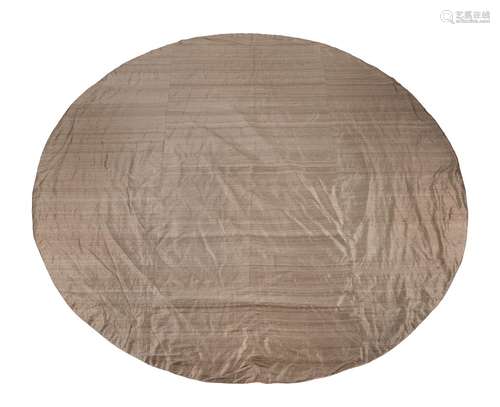 A circular metallic coloured silk table cover