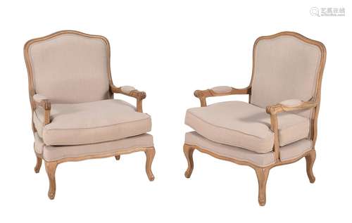 A pair of oak and upholstered armchairs in Louis XV style