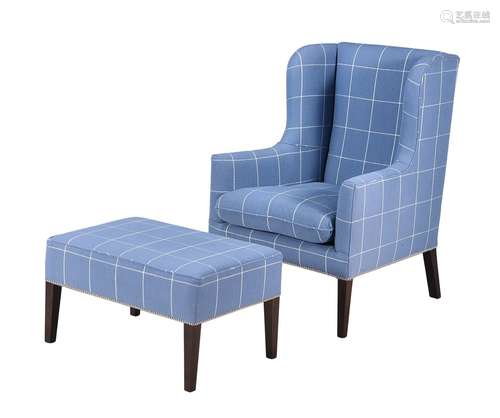 A blue checked upholstered wing armchair