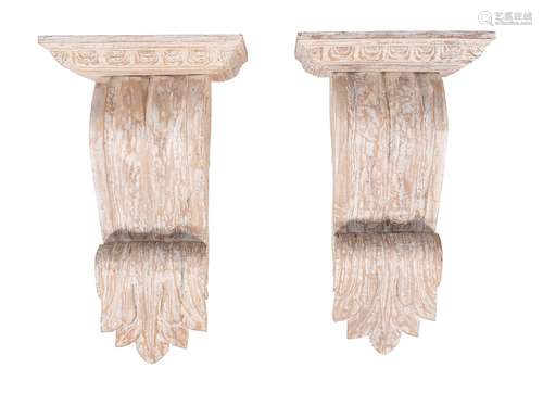 A pair of carved and white painted wood wall brackets