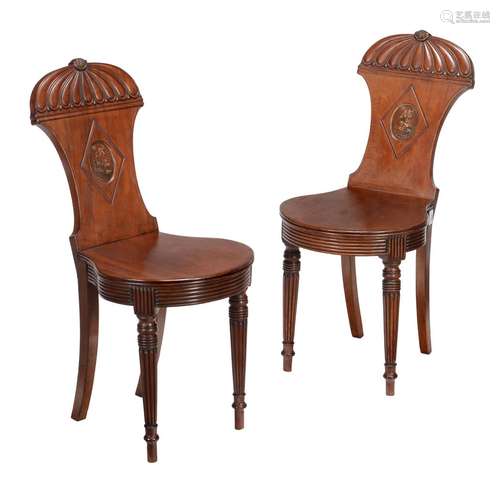 A pair of George IV mahogany hall chairs