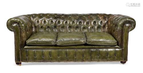A green leather upholstered sofa
