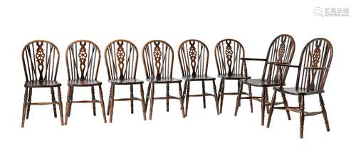 A set of eight beech and elm wheel back dining chairs