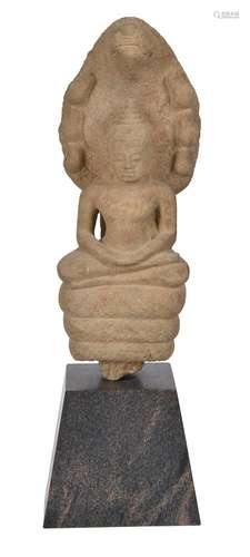 A Khmer sandstone figure of Buddha sheltered by the seven he...