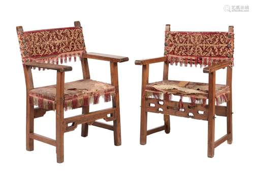 Two similar Iberian walnut open armchairs