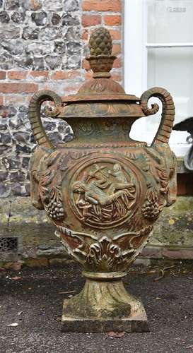 A cast iron urn and cover