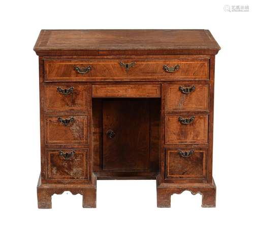 A George II walnut and feather banded kneehole desk