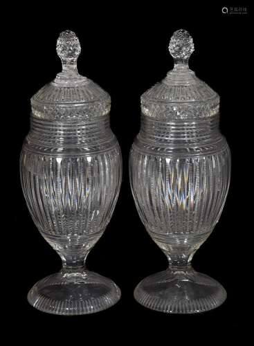 A pair of Continental cut-glass pedestal urns and covers wit...