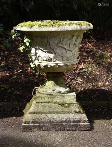 A composition stone urn on stepped base