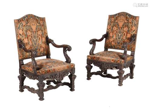 A pair of carved walnut and upholstered armchairs in mid 18t...