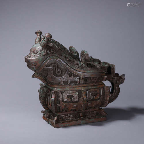 A taotie patterned bronze goat head pot