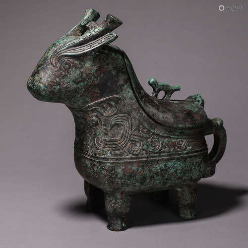 A taotie patterned bronze goat head pot