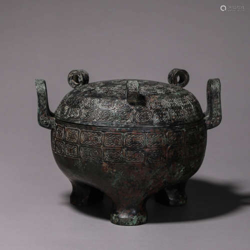 A three-legged round bronze pot