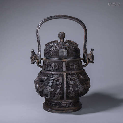 A taotie patterned loop-handled bronze pot