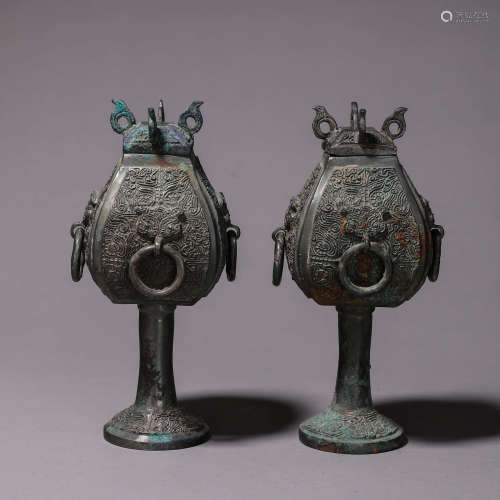 A pair of taotie patterned bronze zun