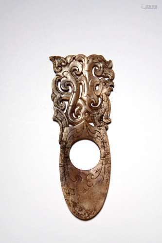 A Carved Brown Jade Dragon And Phoenix Pendant