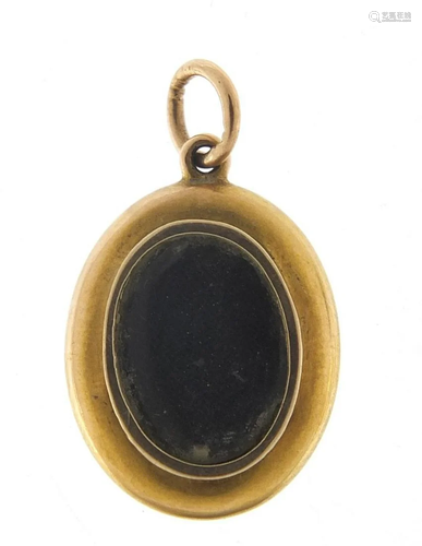 Unmarked gold and enamel mourning locket...