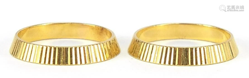 Two 22ct gold wedding bands with engine ...
