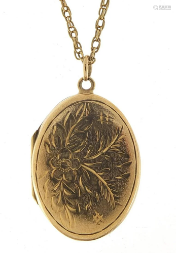 Oval 9ct gold locket with engraved decor...