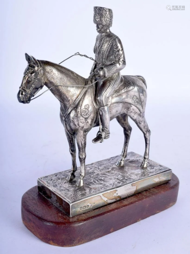 A RARE GEORGE V SILVER FIGURE OF A SOLDIER ON HORSEBA…