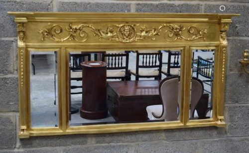 A LARGE REGENCY STYLE GILTWOOD MIRROR decorated with
