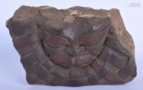 AN EARLY CARVED STONE GROTESQUE MASK HEAD. 30 cm x 22