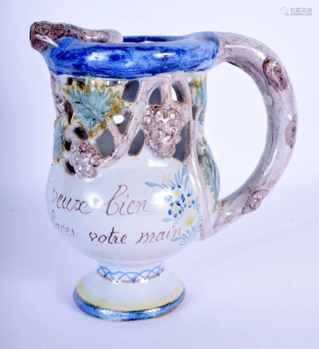 A FRENCH FAIENCE TIN GLAZED PUZZLE JUG. 17 cm high.