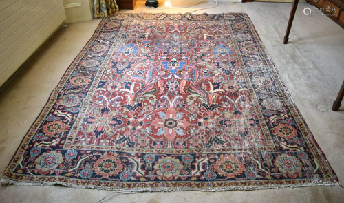 AN ANTIQUE MIDDLE EASTERN CARPET decorated with