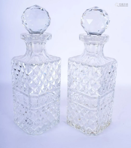 A PAIR OF CRYSTAL GLASS DECANTERS AND STOPPERS. 28 cm