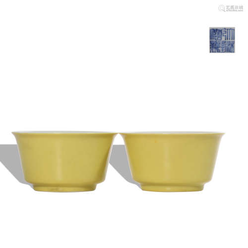 A pair of yellow glazed cup