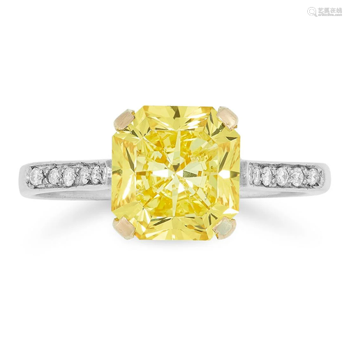 A FINE FANCY VIVID YELLOW DIAMOND AND DIAMOND RING in