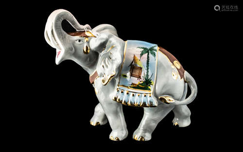 Porcelain Figure of an Elephant with trunk raised, and decor...