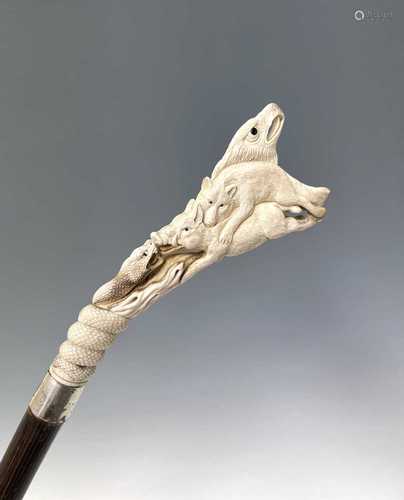 A Japanese carved stag horn walking stick, late 19th century...