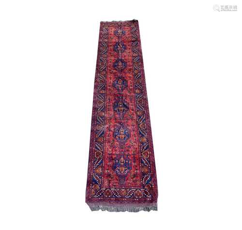 A modern Turkish runner, with seven indigo medallions, 398 x...