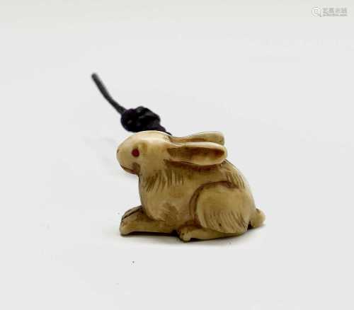 A Japanese ivory netsuke in the form of a hare, circa 1900, ...