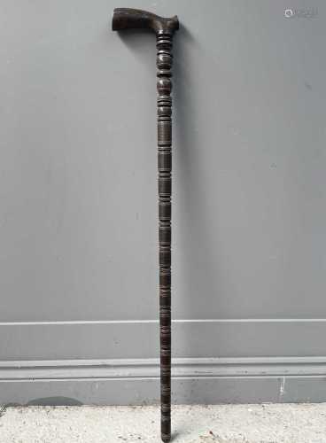 A Persian wooden sectional walking stick, 19th century, with...