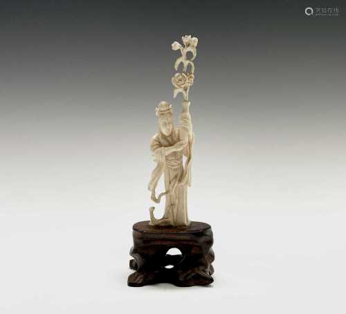 A Chinese ivory figure of a female figure holding a vase of ...