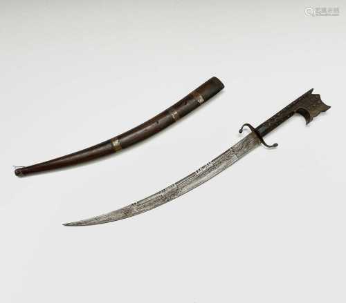A Middle Eastern sword, 19th century, with carved wood handl...