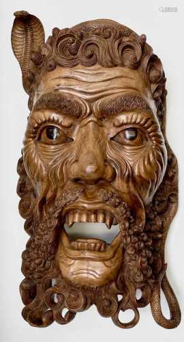 A large South East Asian carved hardwood mask, mid 20th cent...