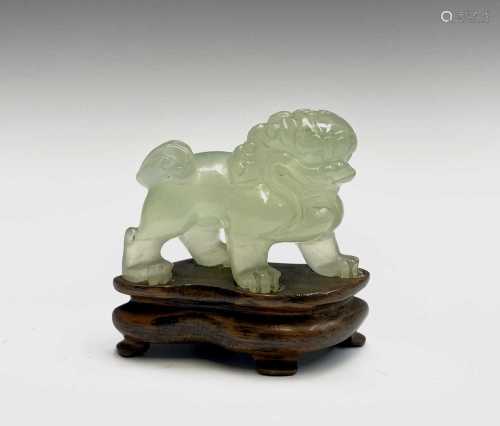 A Chinese jade dog of fo, on a wooden stand, height of figur...