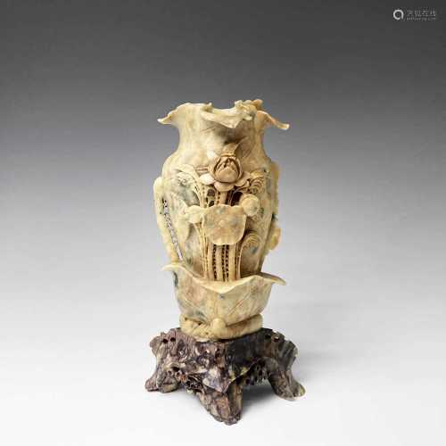 A Chinese soapstone vase, early 20th century, carved with lo...