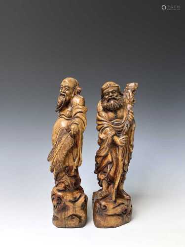 A pair of Chinese hardwood figures of immortals, circa 1900,...