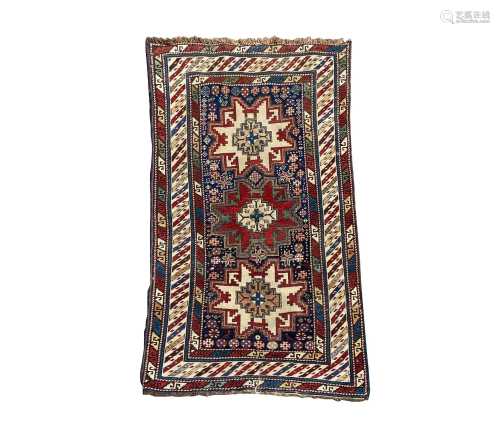 A Lesghi Shirvan rug, the indigo field with three polychrome...