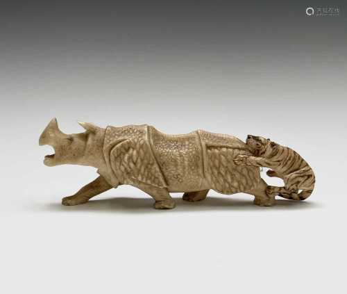 A Japanese ivory carving of a rhinoceros and tiger, 19th cen...
