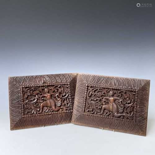 A pair of Tibetan carved wood panels, 20th century, each dec...