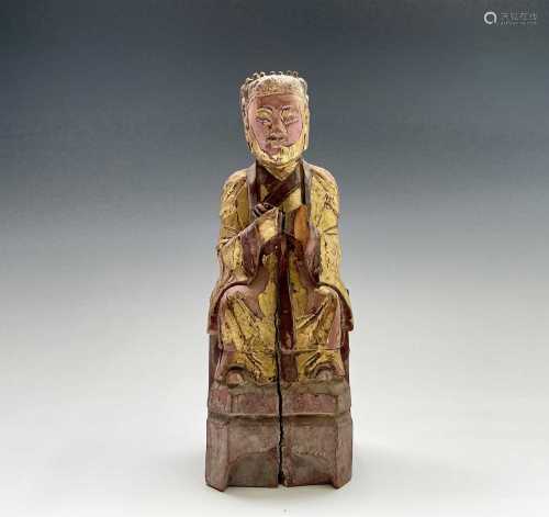 A Chinese gilt carved wood and painted figure of a household...