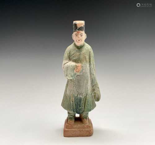 A Chinese glazed pottery figure of a standing dignitary, lat...